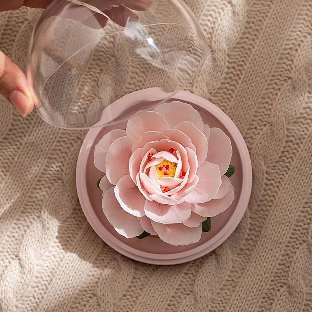 A porcelain flower on a bedside table