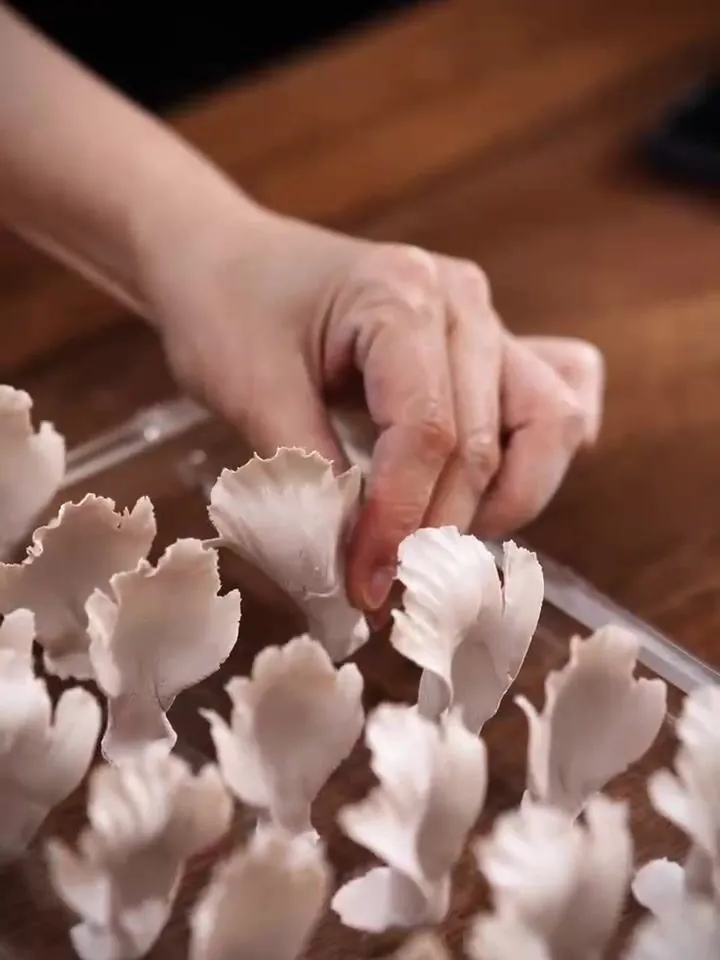 Petals: Petals are pressed thin between finger and thumb and curved while the clay is soft.